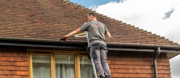 our team cleaning the gutters on a house in Lincoln